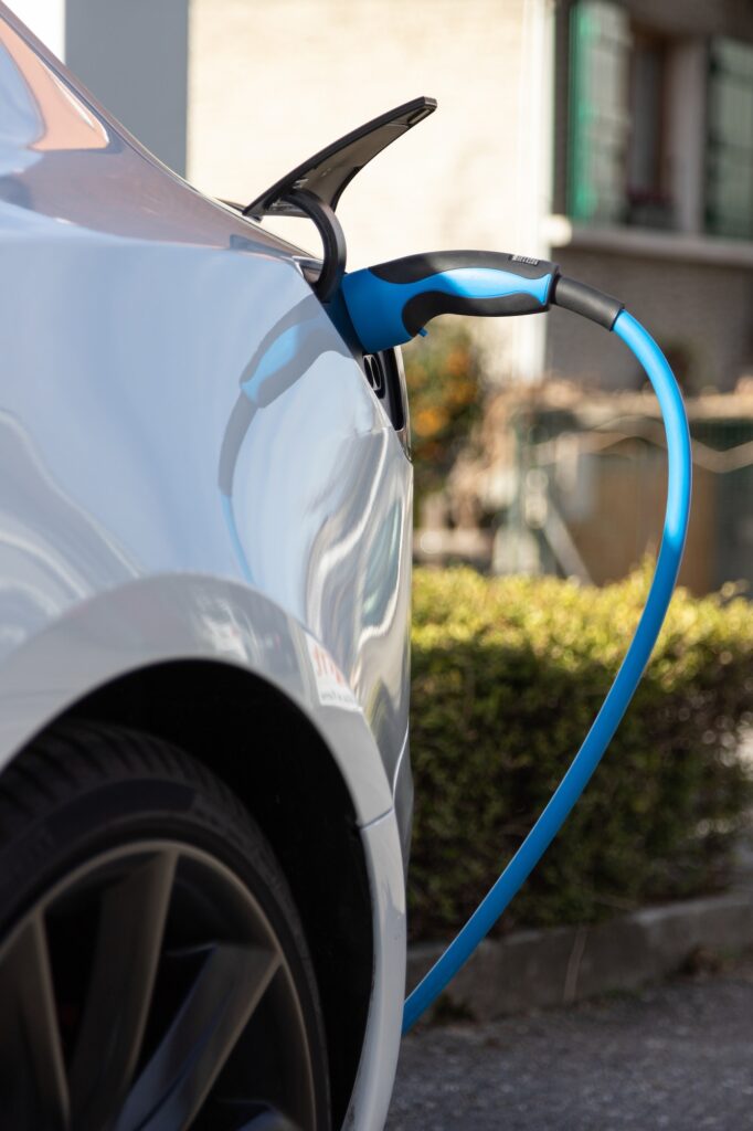 EV electric car pluged charging at a recharge station in the city