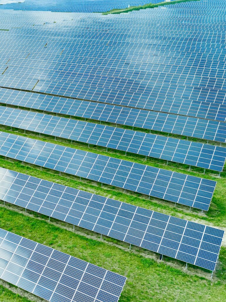 Solar panels producing green renewable energy. Solar power station in the field with green grass